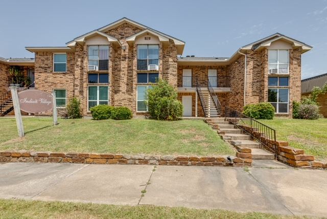 Two-story brick buildings facing Apache Drive