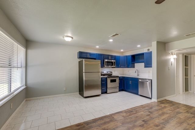 Open kitchen and dining area with blue cabinets