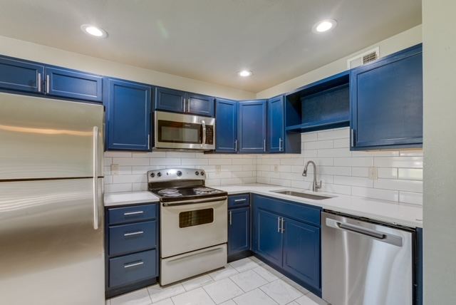 Kitchen with stainless refrigerator, range and dishwasher