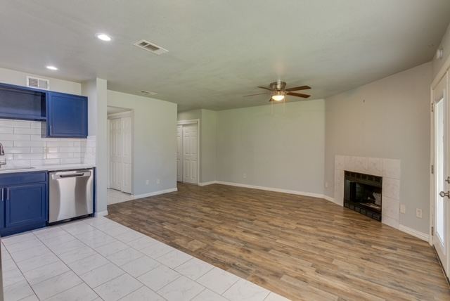 Open living area with fireplace and wood-style flooring