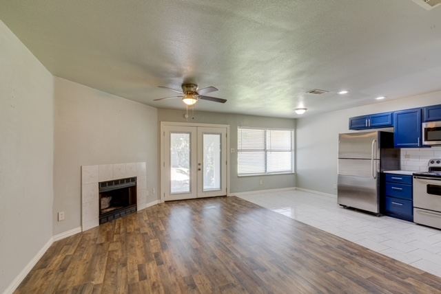 Living room with ceiling fan and fireplace