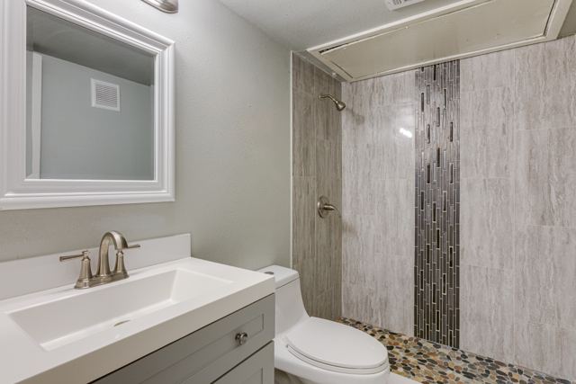 Updated bathroom with tiled shower and modern vanity