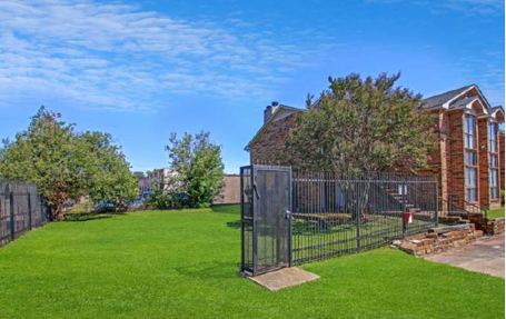 Fenced green space on the grounds